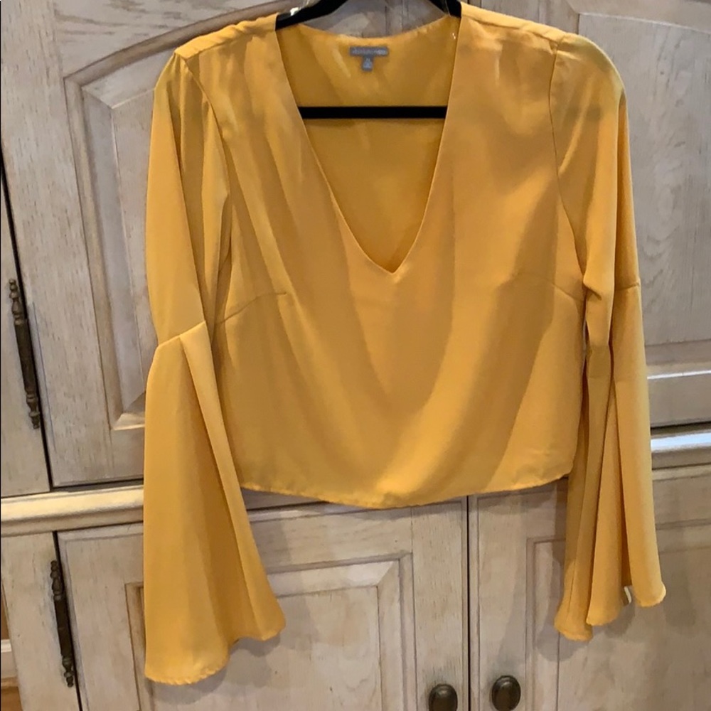 NWOT yellow silk like blouse with bell sleeves.